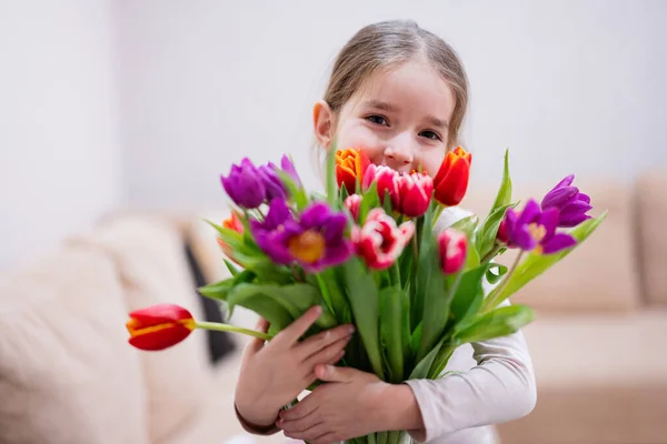 stock image Little girl with spring tulip bouquet.  Holiday decor with flowers colorful tulips. 