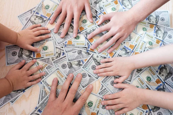 Kids hands on dollar money. Distribution of family property.