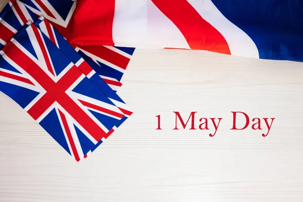 First of May Day. British holidays concept. Holiday in United Kingdom. Great Britain flag background.