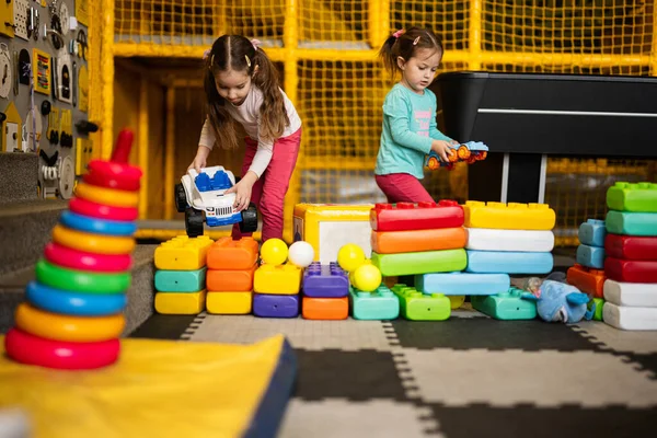 Two Sisters Playing Kids Play Center While Build Colored Plastic — Stock Photo, Image