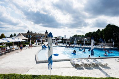 Aqua Paradise Nessebar, Bulgaristan - 19 Haziran 2023: Şemsiyeler ve güneşlik yataklarla havuz.
