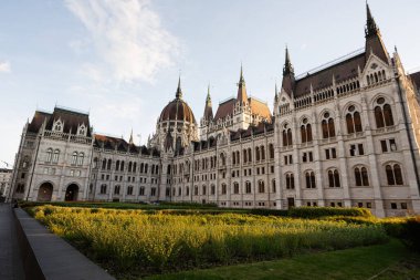 Günbatımında tarihi parlamento binası ve bitişik bahçenin geniş açılı çekimi, mimari ihtişamı gözler önüne seriyor..