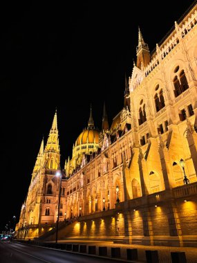 Explore the stunning architectural design of the illuminated parliament building captured at night, showcasing its grandeur and intricate details against the dark sky. Hungarian Parliament Building. clipart