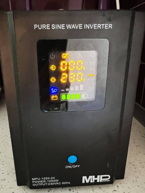 Kyiv, Ukraine - December 02, 2024: Pure sine wave inverter showing its digital display with various readings. Ideal for illustrating electricity management, power solutions, and modern technology  clipart