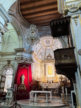 Positano, Italy - July 19, 2022: Eelegant interior of a historic church, showcasing exquisite architectural details, ornate decorations, and a serene atmosphere, highlighted by a grand chandelier clipart