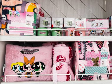 Kyiv, Ukraine - December 18, 2024: Shelves filled with cartoon-character products including blankets, pillows, mugs, and gift items, featuring vibrant colors and appealing designs, making it perfect for children or fans of popular cartoon characters. clipart