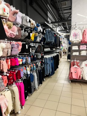 Kyiv, Ukraine - December 18, 2024: A retail store showcasing clothing and accessories for children, organized neatly in sections. Bright colors and diverse textures add visual appeal. The store offers seasonal clothing, showcasing stylish options for clipart