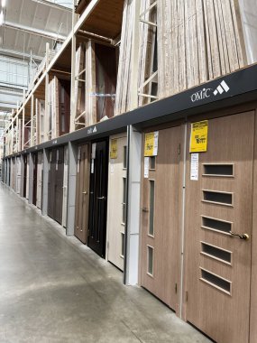 Kyiv, Ukraine - January 03, 2025: An assortment of door models showcased at a home repair and improvement market, offering various styles and materials. A view of the store interior showcasing hardware and construction materials. clipart