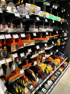 Kyiv, Ukraine - January 03, 2025: A detailed view inside a hardware store showcasing neatly organized construction tools and painting equipment arranged on multiple shelves. clipart