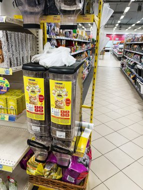 Kyiv, Ukraine - February 04, 2025: Retail shop aisle offering pet food and products in self-serve dispensers and packaging. clipart