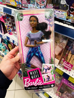 Kyiv, Ukraine - February 04, 2025: A packaged Barbie doll with yoga pose theme, titled 'Made to Move', in store. clipart