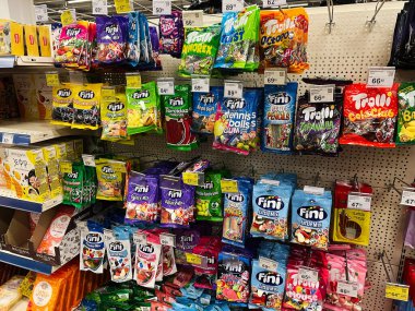 Kyiv, Ukraine - February 04, 2025: Variety of colorful packaged candies and gummies neatly displayed in a grocery store. clipart