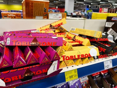 Kyiv, Ukraine - February 04, 2025: Colorful assortment of triangular chocolate bars organized on a supermarket shelf display clipart