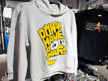 Kyiv, Ukraine - February 05, 2025: Hoodies showcasing creative expressions and beloved  Bart Simpson characters in a casual retail environment clipart