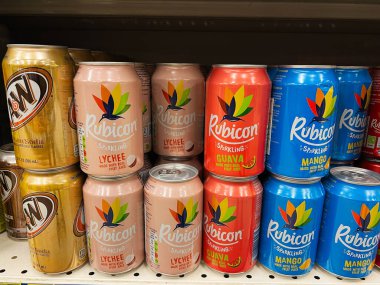 Kyiv, Ukraine - February 04, 2025: Assorted Rubicon cans of sparkling fruit beverages displayed on a neatly arranged supermarket shelf. clipart