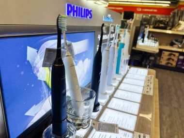 Kyiv, Ukraine - February 09, 2025: A variety of Philips Sonicare modern electric toothbrushes exhibited for sale in a department store.  clipart