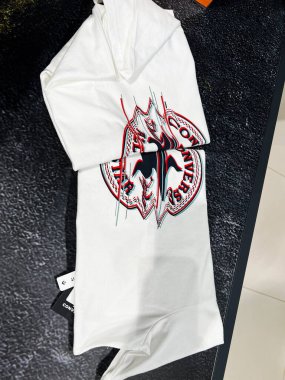 Kyiv, Ukrayna - 09 Şubat 2025: Kalın bir Converse All Star logosu ve çarpıcı kırmızı grafikleri olan şık beyaz bir tişört.