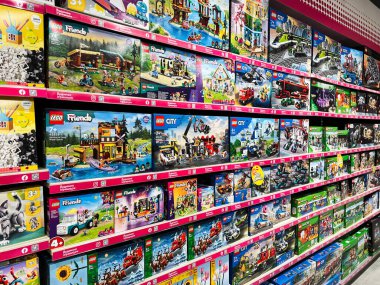 Kyiv, Ukraine - February 09, 2025: Various vibrant Lego toy sets neatly organized on retail shelves in a store clipart