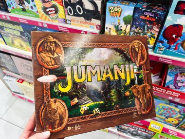 Kyiv, Ukraine - February 09, 2025: Board game Jumanji showcased in store among a variety of colorful board games. clipart