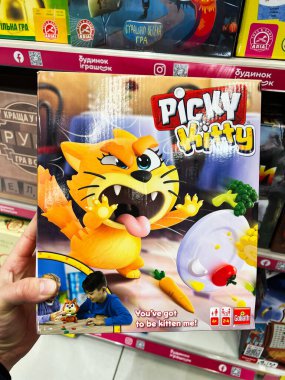 Kyiv, Ukraine - February 09, 2025: Box of the Picky Kitty game displayed in a store showing detailed design. clipart