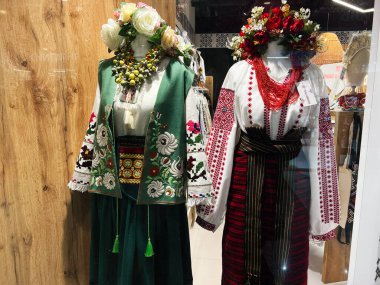 Kyiv, Ukraine - February 09, 2025: Traditional ukrainian vyshyvanka outfits with embroidery and floral patterns displayed with intricate decorations indoors.  clipart