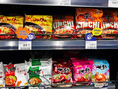 Kyiv, Ukraine - February 11, 2025: Displayed are multiple instant Nongshim noodle varieties arranged on display shelves in a store. clipart