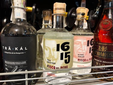 Kyiv, Ukrayna - 11 Şubat 2025: Bir içki dükkanının rafındaki çeşitli içkiler ve Pisco şişeleri.