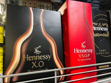 Kyiv, Ukraine - February 11, 2025: Multiple Hennessy cognac boxes with distinct designs and labels arranged for display. clipart