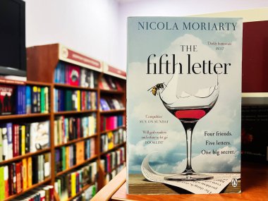 Lviv, Ukraine - February 13, 2025: A book The Fifth Letter by Nicola Moriarty cover captured in a bookstore, showcasing a mystery novel's theme and style. clipart