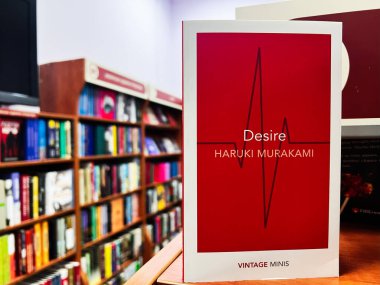 Lviv, Ukraine - February 13, 2025: A hardcover book Haruki Murakami Desire on a shelf in a colorful and organized bookstore clipart