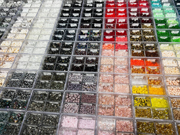 Lviv, Ukraine - February 13, 2025: Various types and colors of beads displayed in organized compartments for creative crafting