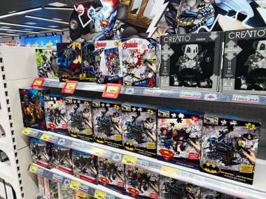 Lviv, Ukrayna - 16 Şubat 2025: Popüler DC ve Marvel karakterlerinin yer aldığı süper kahraman bulmacaları ve oyuncaklarıyla dizilmiş raflar.