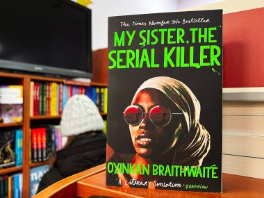 Lviv, Ukraine - February 20, 2025: The novel 'My Sister, The Serial Killer' by Oyinkan Braithwaite on display. clipart