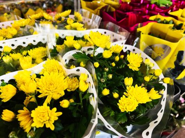 Captivating yellow flowers beautifully arranged in decorative wrapping for gifting or display. clipart