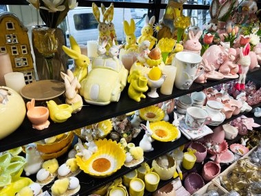 A variety of Easter decorations including bunnies, eggs, yellow ceramics, and spring flowers. clipart