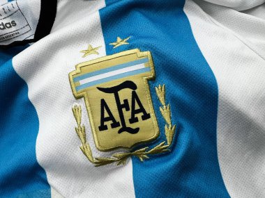 Kyiv, Ukraine - February 27, 2025: Detailed view of a sports Argentina home jersey showcasing a prominent embroidered logo design. clipart