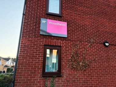 London, UK - March 02, 2025: Exterior view of building with a Woodfields sign, window, and climbing plants on wall clipart