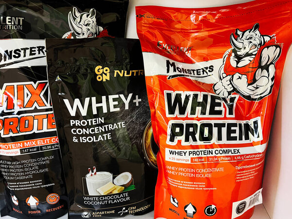 Kyiv, Ukraine - March 04, 2025: Several whey protein supplement packages promoting nutrition and fitness benefits for health
