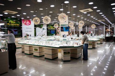 Lviv, Ukrayna - 17 Mart 2025: Parlak Ukr Zoloto mücevher mağazası modern tasarım ve lüks vitrinleri inceleyen müşteriler.