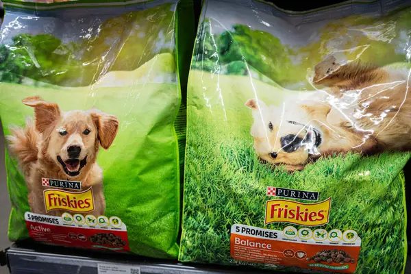 Lviv, Ukrayna - 25 Mart 2025: Frizbiler canlı açık hava temaları ve ayrıntılı ambalajlarla gösterilen köpek mamaları