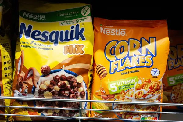 Lviv, Ukrayna - 25 Mart 2025: Nestle Nesquik ve Corn Flakes mısır gevreği paketleri bir mağazanın rafında sergilendi