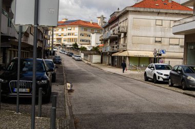 Fatima, Portekiz - 24 Mart 2025: Fatima, Portekiz 'de bir yerleşim yeri binalar, arabalar ve yalnız bir yaya.