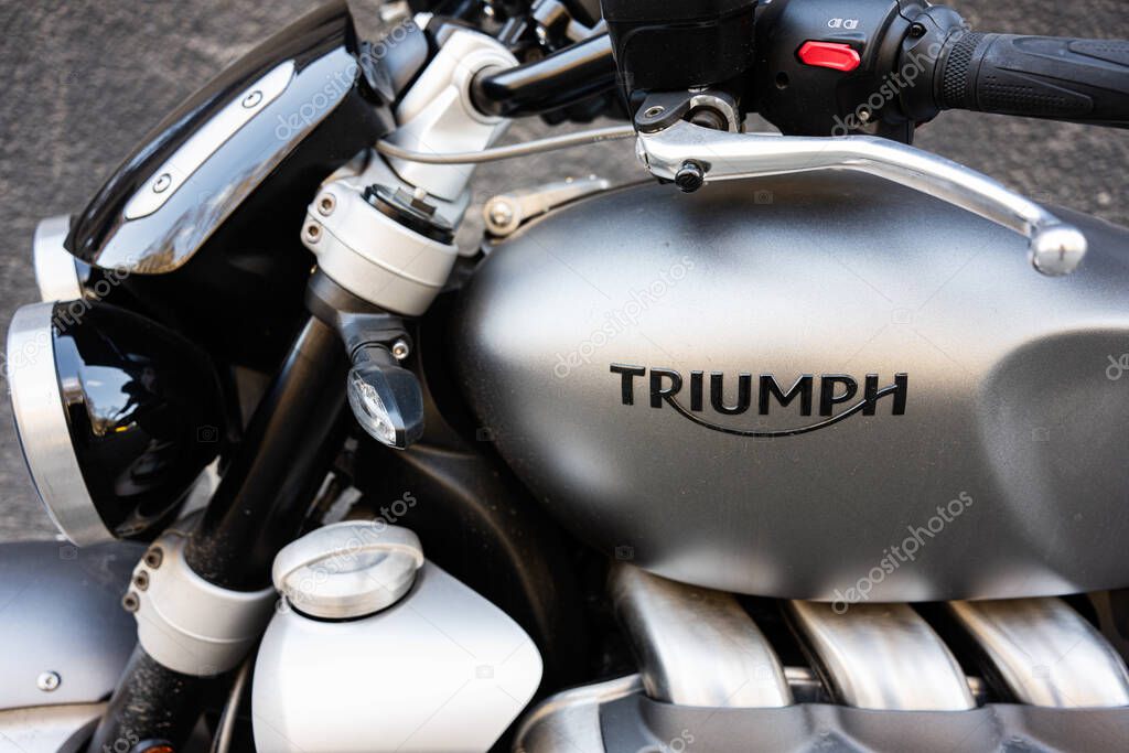 Lviv, Ukraine - April 06, 2025: Detailed view of a Triumph motorcycle, showcasing its emblem and components.