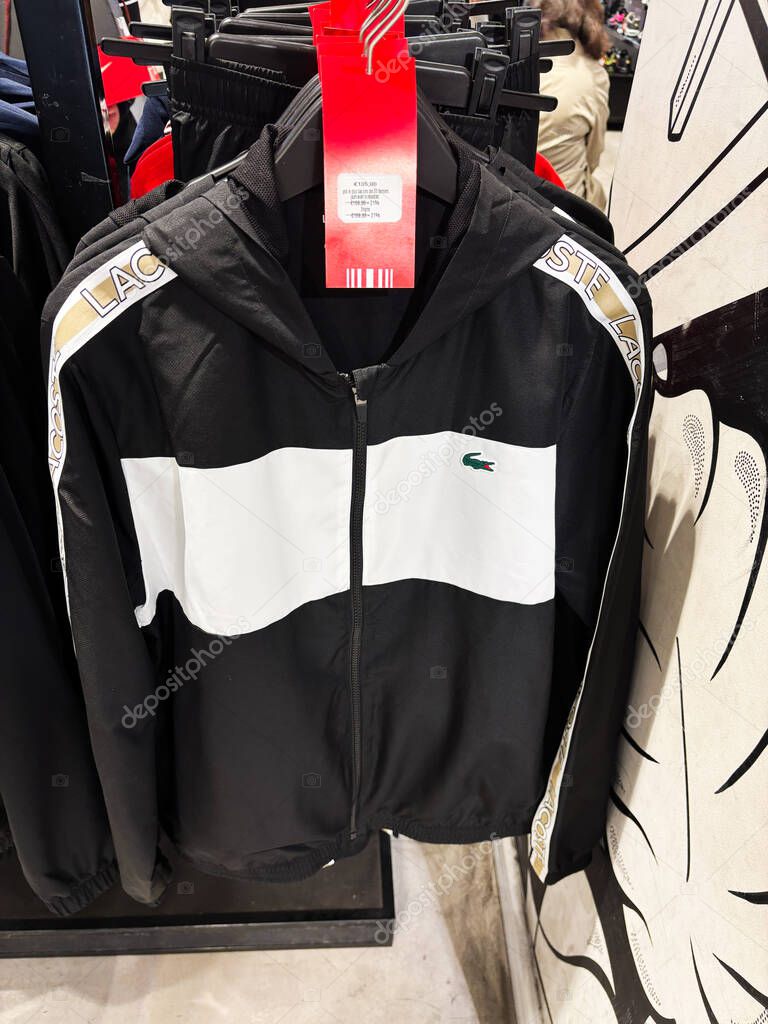 Paris, France - March 28, 2025: High-quality black and white Lacoste hoodie with brand details and fashionable design