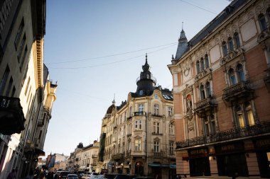 Lviv, Ukrayna - 07 Nisan 2025: Lviv 'in şehir merkezinde güneşli hava ve açık gökyüzü ile süslü tarihi mimari.