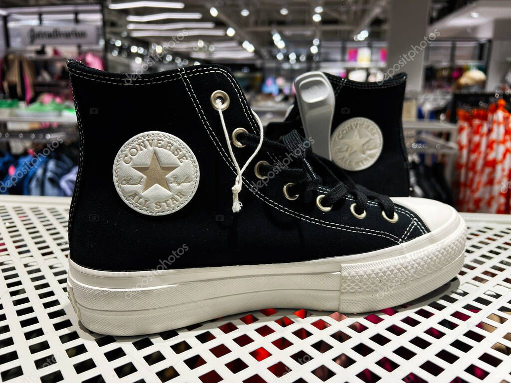 Kyiv, Ukraine - April 08, 2025: Classic black Converse All Star sneakers with a star logo displayed in a modern retail store.