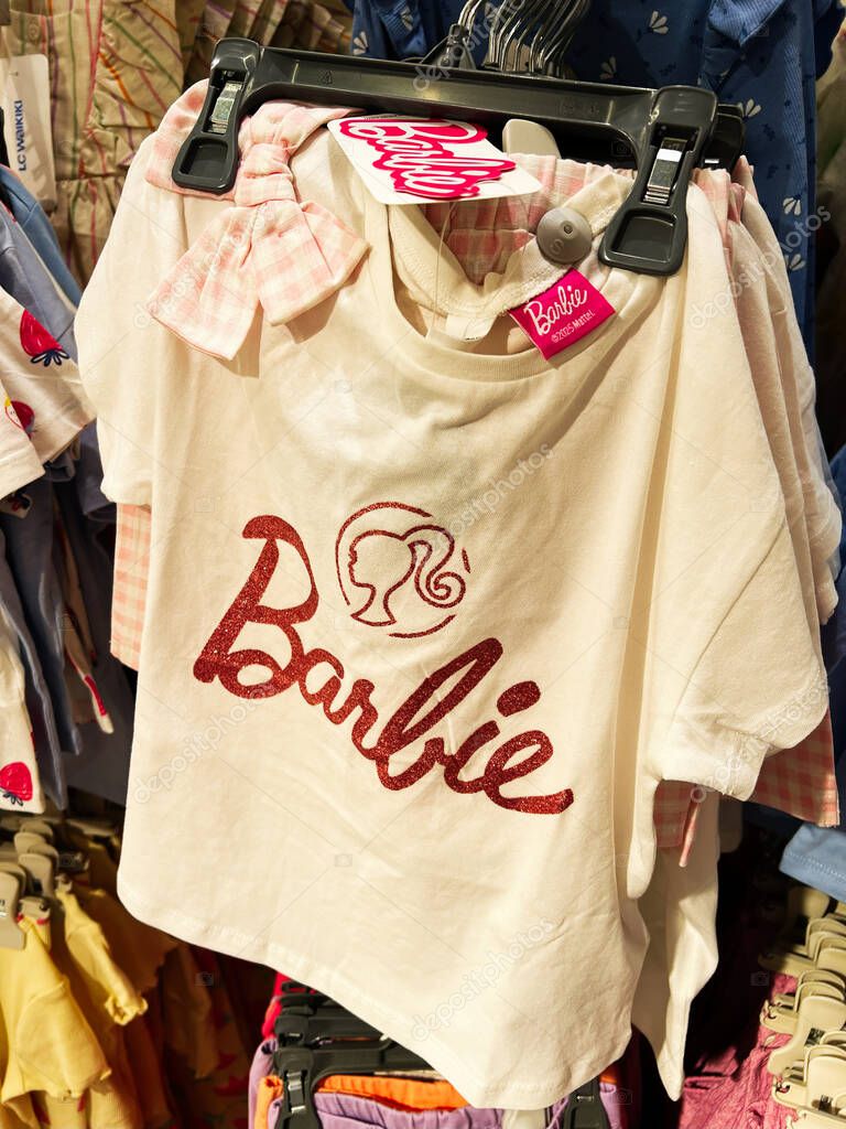 Kyiv, Ukraine - April 08, 2025: Elegant Barbie T-shirt with sparkly text showcased in a retail clothing store