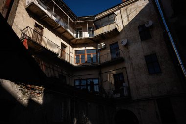 Lviv 'de gölgeli duvarları olan tarihi bir binanın iç avlusunun görüntüsü.