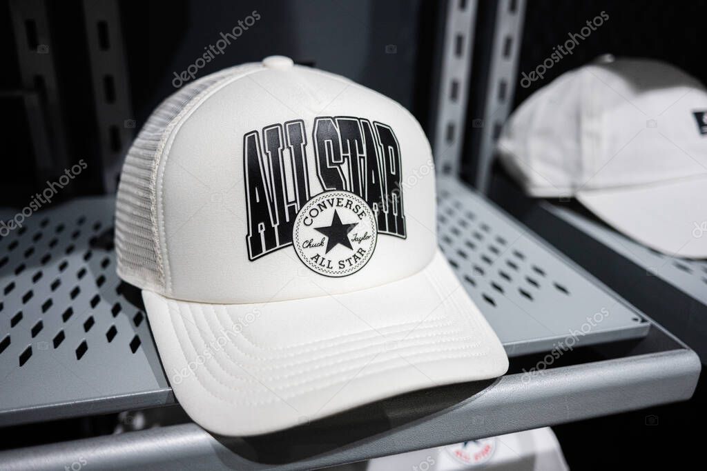 Khmelnytskyi, Ukraine - April 16, 2025: Close-up of white cap featuring All Star text and Converse logo placed on retail shelf