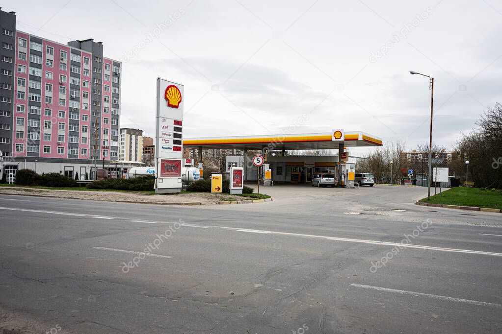 Khmelnytskyi, Ukraine - April 16, 2025: Modern Shell gas station situated near urban residential buildings and cars providing service